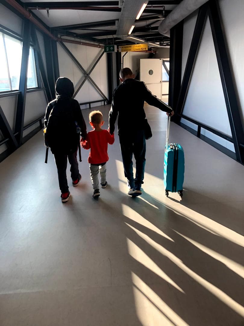 Travellers walking through airport corridor